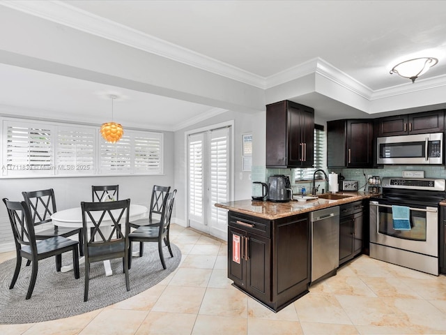 kitchen featuring light stone countertops, appliances with stainless steel finishes, tasteful backsplash, and crown molding