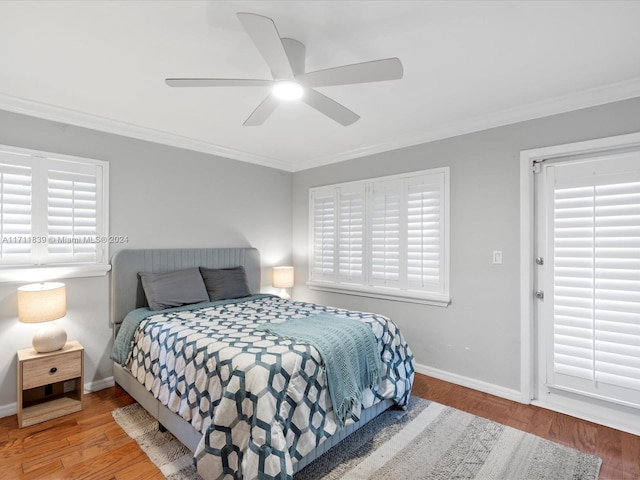 bedroom featuring hardwood / wood-style flooring, ceiling fan, and crown molding