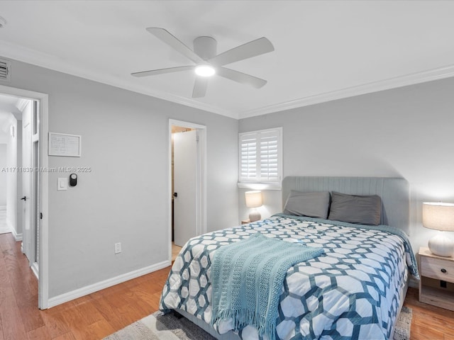 bedroom featuring hardwood / wood-style floors, ceiling fan, and crown molding