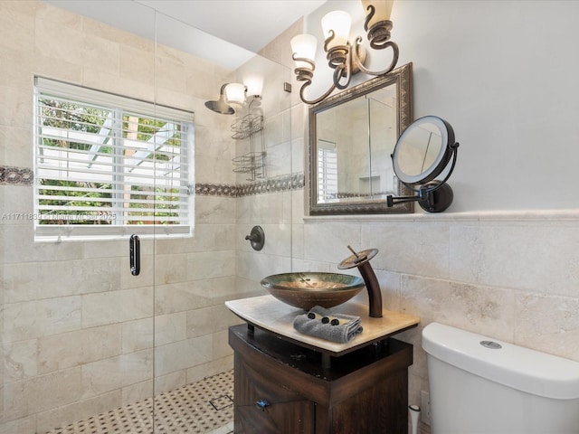 bathroom featuring tile walls, vanity, an enclosed shower, and toilet