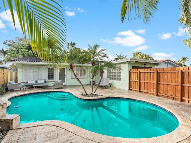 view of pool featuring an outdoor living space and a patio area