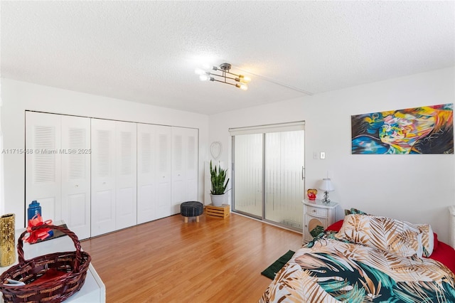 interior space featuring a closet, a textured ceiling, and hardwood / wood-style flooring