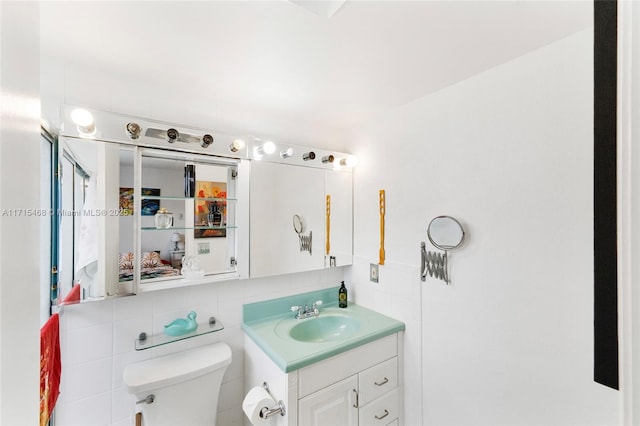 bathroom featuring backsplash, vanity, tile walls, and toilet