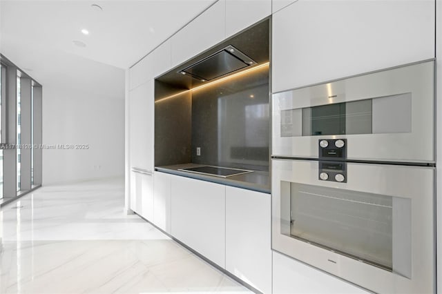 kitchen with stainless steel double oven, tasteful backsplash, white cabinetry, and black electric cooktop