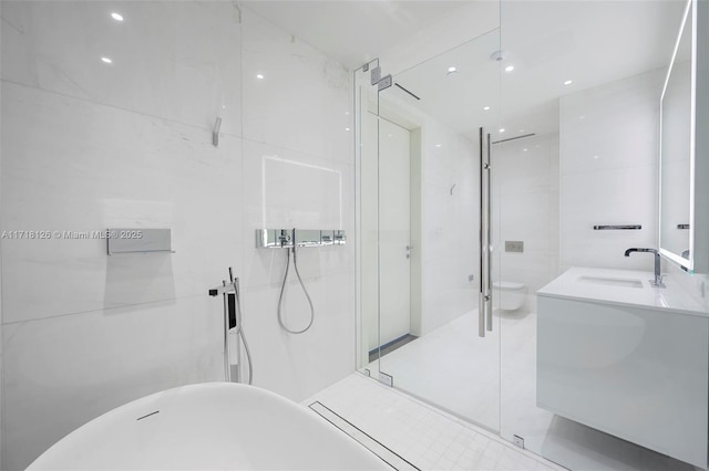 full bathroom with vanity, toilet, tile walls, and independent shower and bath