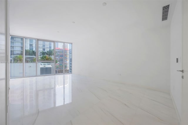 unfurnished room with floor to ceiling windows