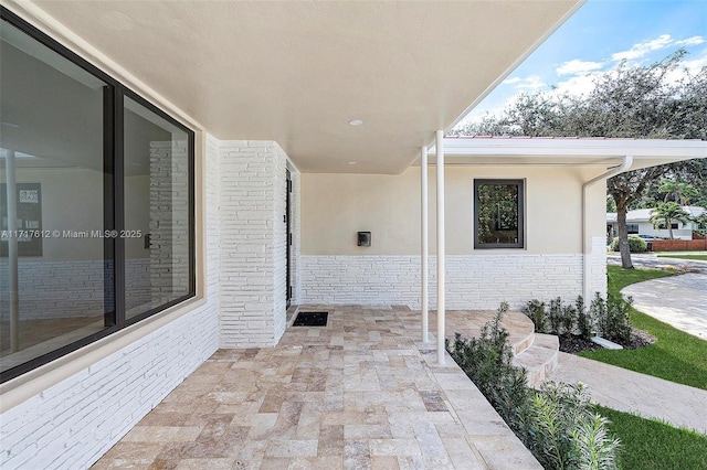 entrance to property with a patio