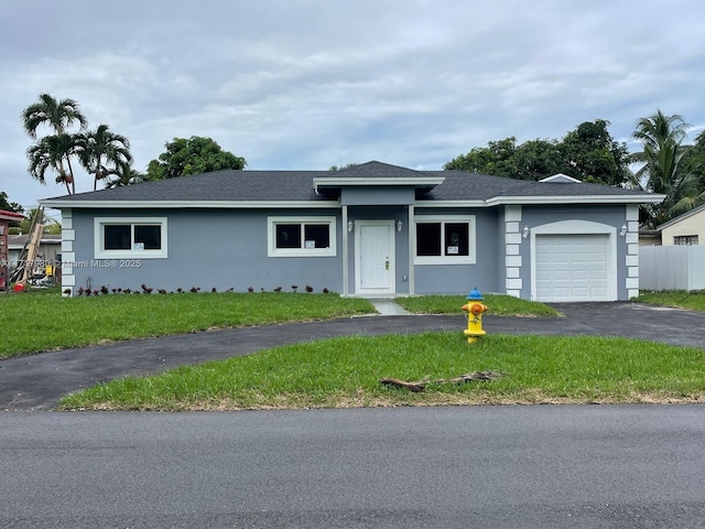 view of front facade with a garage and a front lawn