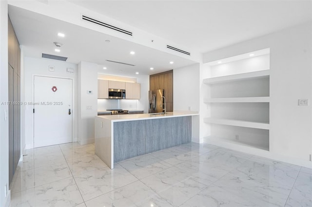 kitchen with kitchen peninsula, built in features, and stainless steel appliances