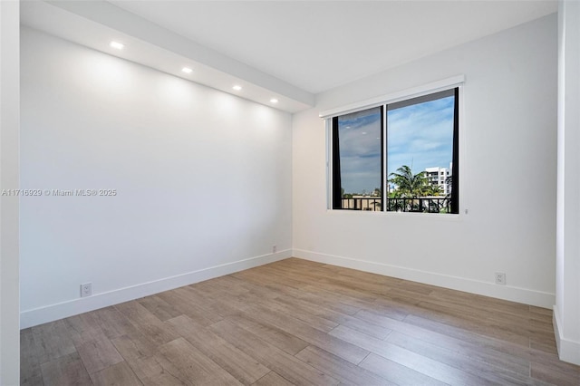 empty room with light hardwood / wood-style flooring