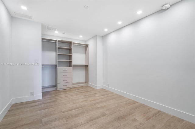 spacious closet featuring light hardwood / wood-style floors