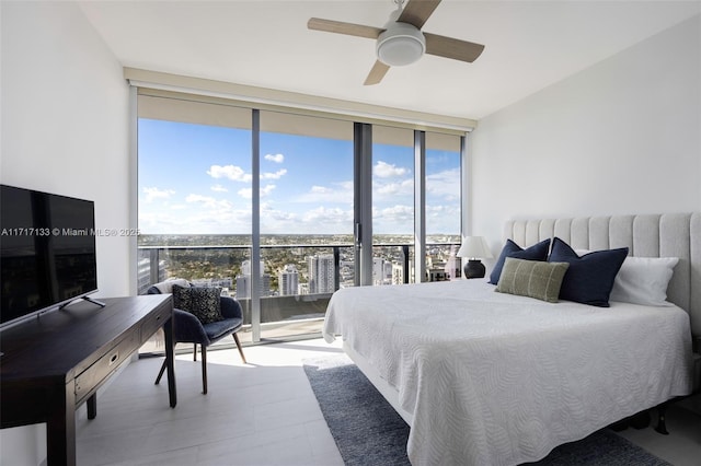 bedroom featuring access to outside, a wall of windows, and ceiling fan