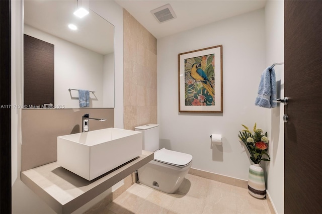 bathroom featuring tile patterned floors, sink, and toilet