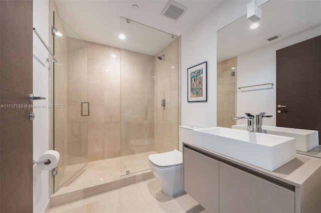 bathroom featuring tile patterned flooring, vanity, toilet, and walk in shower