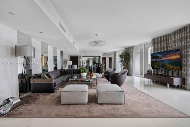 living room with tile patterned floors, a notable chandelier, and expansive windows