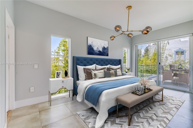 bedroom with a chandelier, access to outside, and multiple windows