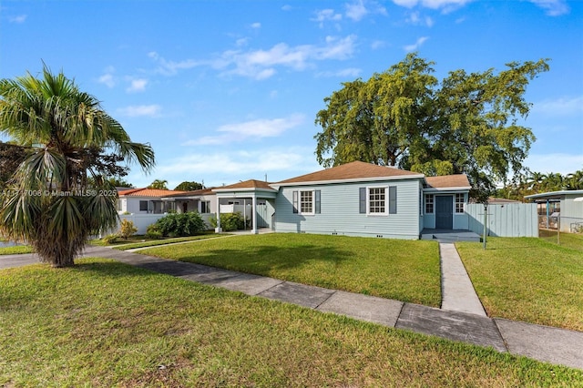 ranch-style home featuring a front yard and a carport