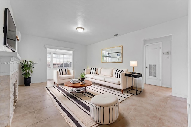 tiled living room with a fireplace