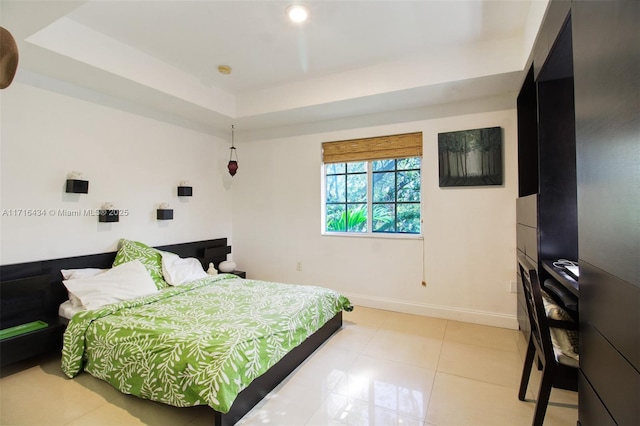 tiled bedroom with a tray ceiling