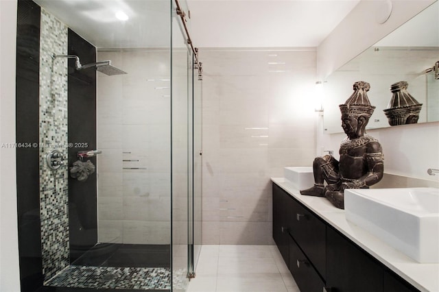 bathroom featuring tile patterned floors, vanity, and walk in shower