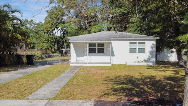 bungalow with a front lawn and covered porch