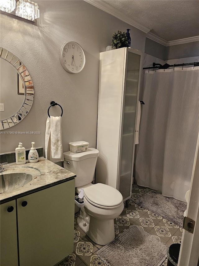 bathroom with vanity, a textured ceiling, crown molding, tile patterned flooring, and toilet