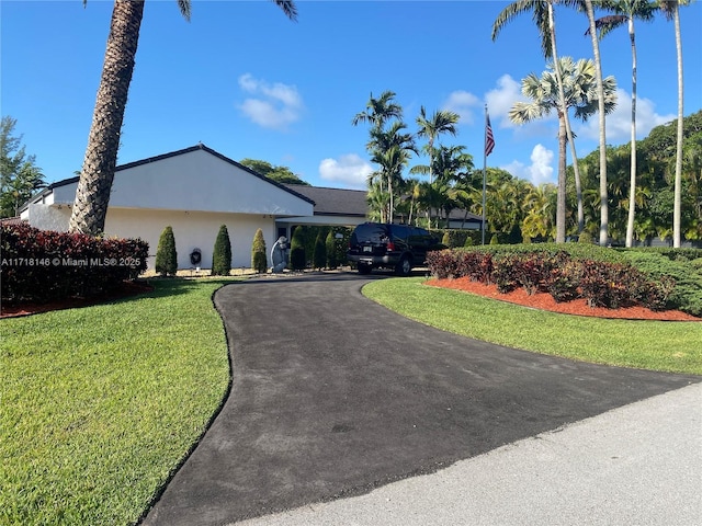 single story home with a front lawn