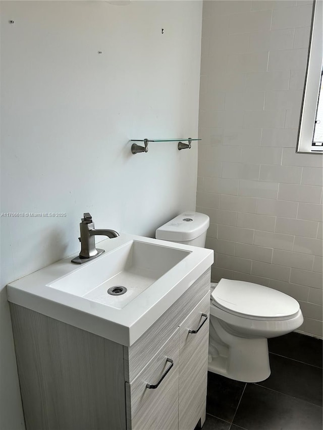 bathroom with vanity, tile patterned floors, and toilet