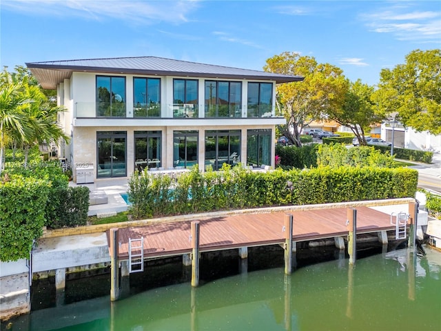 rear view of house featuring a water view