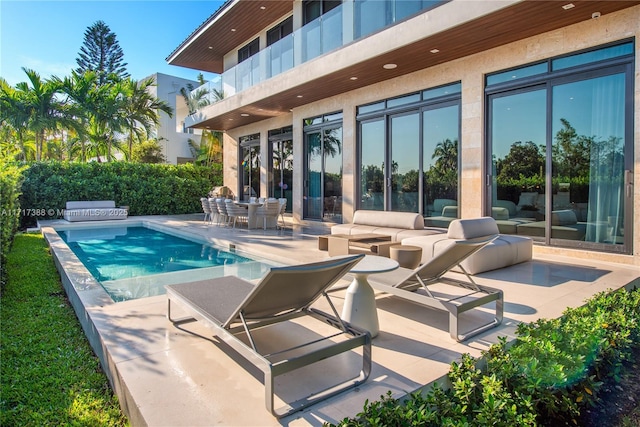 view of pool featuring area for grilling and a patio area