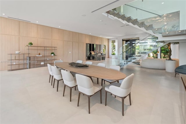 dining space featuring wooden walls
