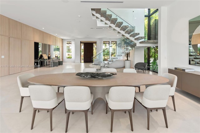 dining room with a wealth of natural light and wooden walls