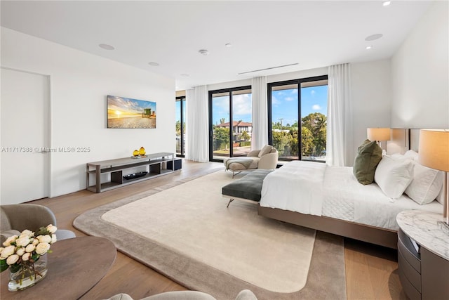 bedroom with access to exterior and light wood-type flooring