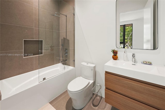 full bathroom with tile patterned floors, vanity, toilet, and bath / shower combo with glass door