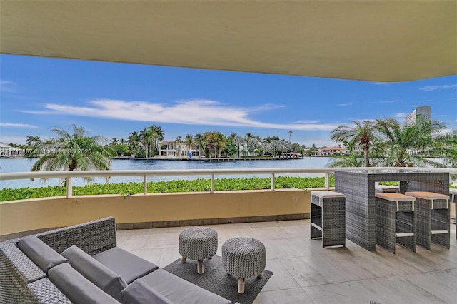 view of patio / terrace with a water view and an outdoor living space