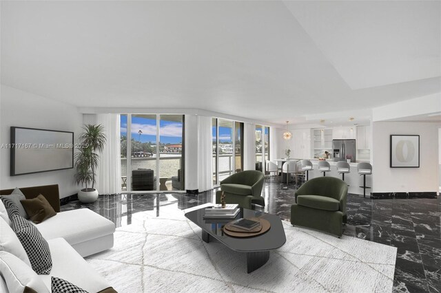 living room featuring expansive windows and a water view