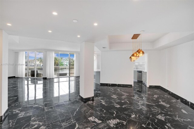 unfurnished room with a tray ceiling