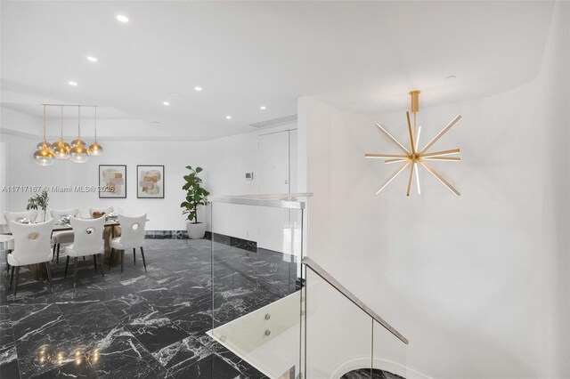 unfurnished dining area with a notable chandelier