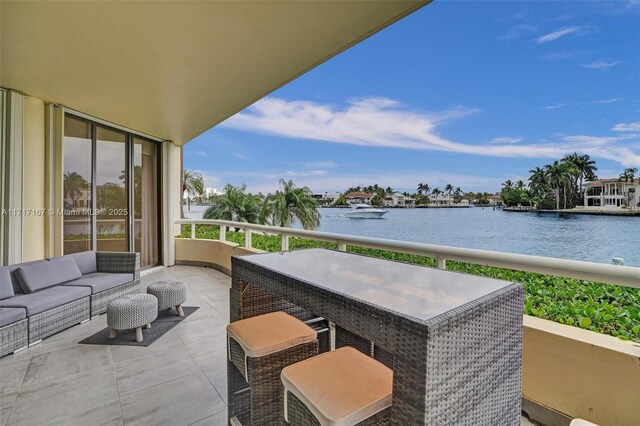 balcony with a water view and outdoor lounge area