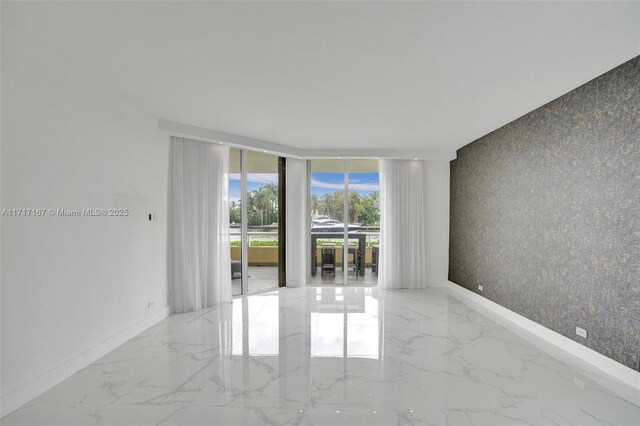 unfurnished room featuring floor to ceiling windows