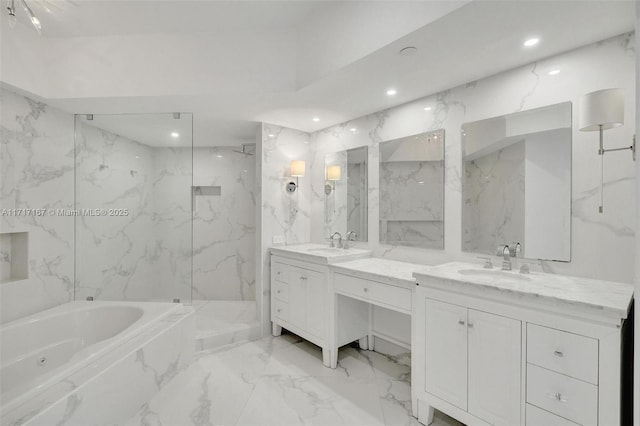 bathroom with vanity and shower with separate bathtub