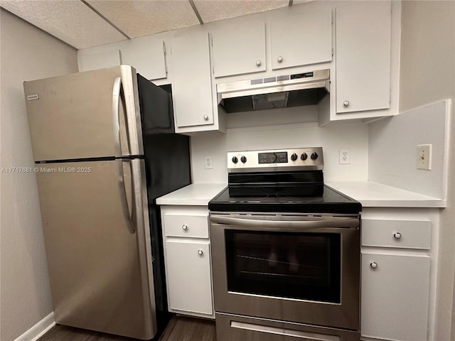 kitchen featuring a paneled ceiling, white cabinetry, dark hardwood / wood-style flooring, and appliances with stainless steel finishes