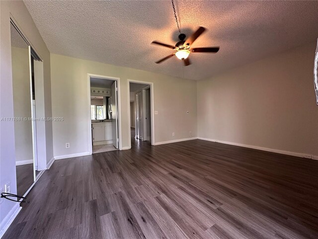 151 SW 135th Ter Unit 106T, Pembroke Pines, FL 33027 - kitchen featuring under cabinet range hood, stainless steel appliances, dark wood-type flooring, and light countertops