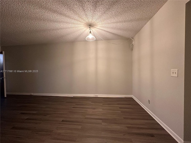 unfurnished room featuring dark hardwood / wood-style flooring and a textured ceiling