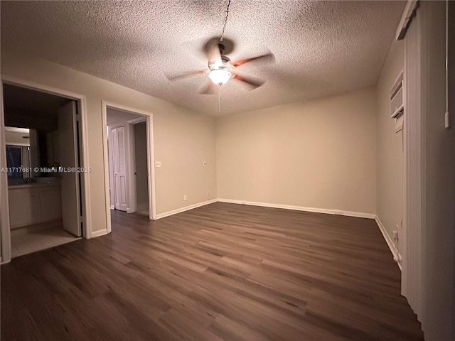 unfurnished bedroom with ensuite bath, ceiling fan, dark hardwood / wood-style flooring, and a textured ceiling