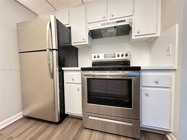 kitchen featuring white cabinets, appliances with stainless steel finishes, light countertops, light wood-style flooring, and under cabinet range hood