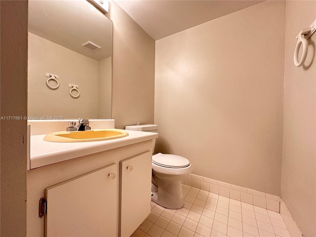 bathroom with tile patterned flooring, vanity, and toilet