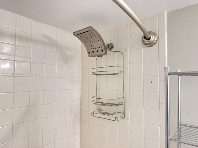 interior details featuring a tile shower