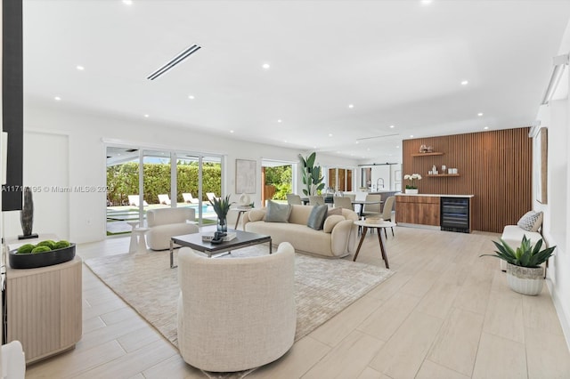 living room featuring wooden walls and wet bar