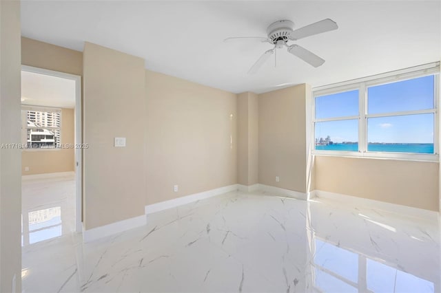 unfurnished room featuring a water view, plenty of natural light, and ceiling fan